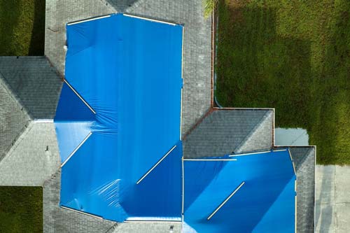 Blue tarps on a roof - aerial view